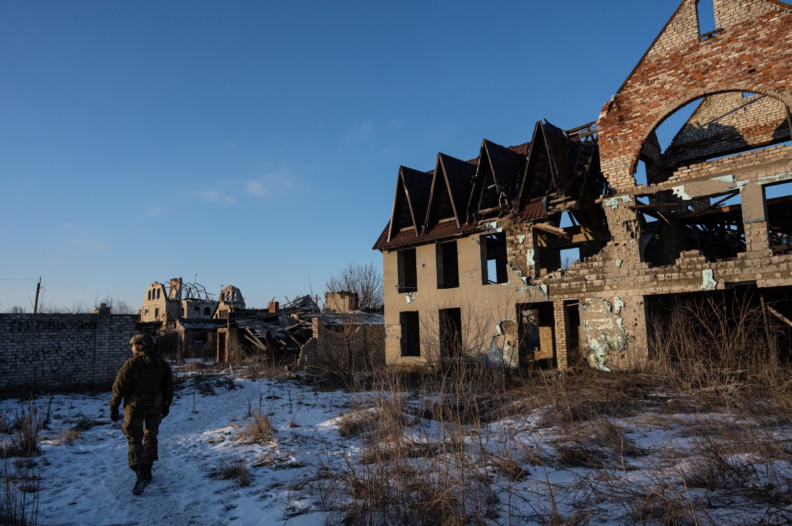 A Ukrainian soldier walks by an abandoned building in the city of Donetsk, Ukraine, Feb. 5, 2022. (AA Photo)