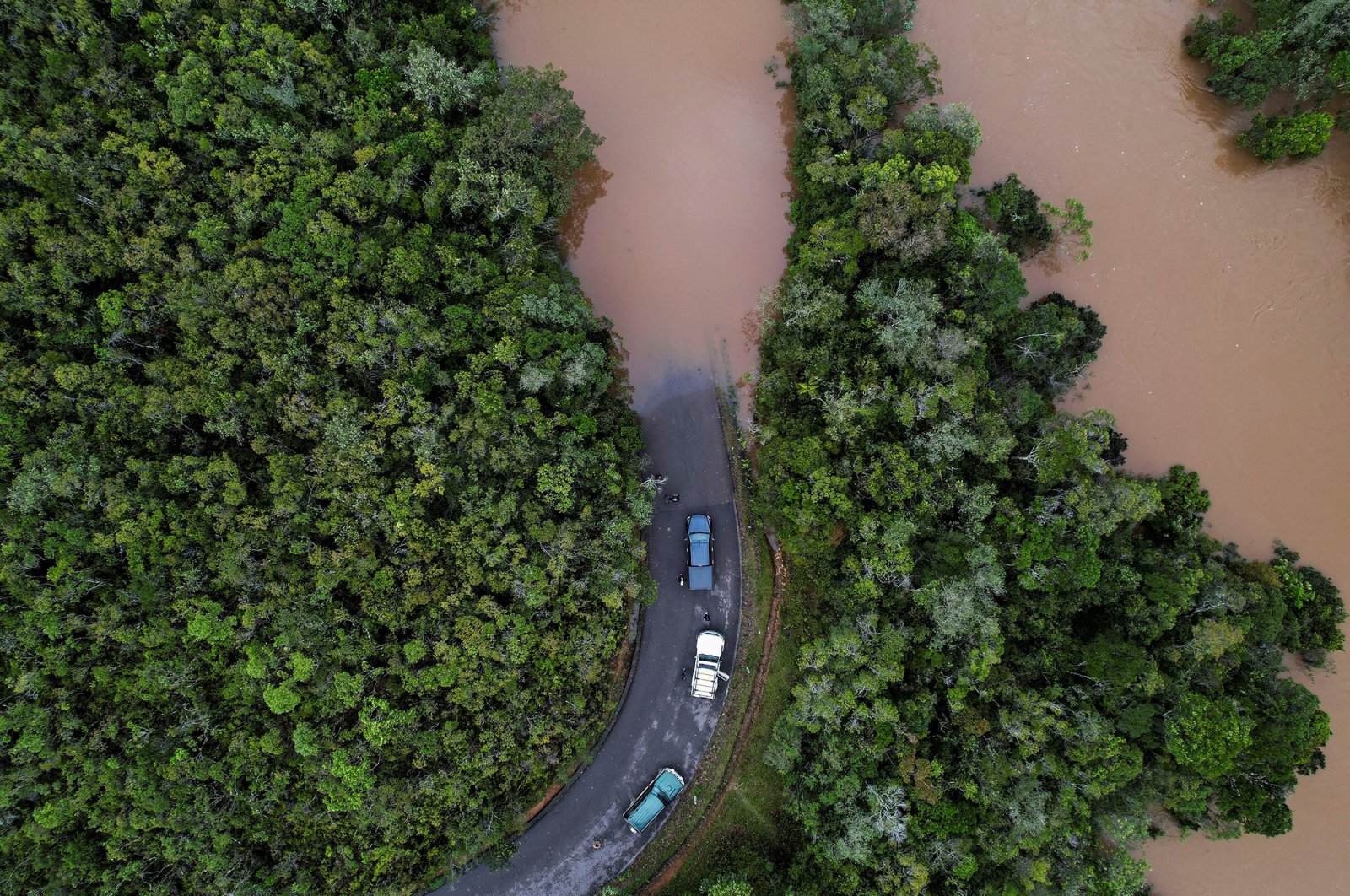 Cars stop before a flooded area, after Cyclone Batsirai made landfall, on a road in Vohiparara, Madagascar, Feb. 6, 2022. (Reuters Photo)