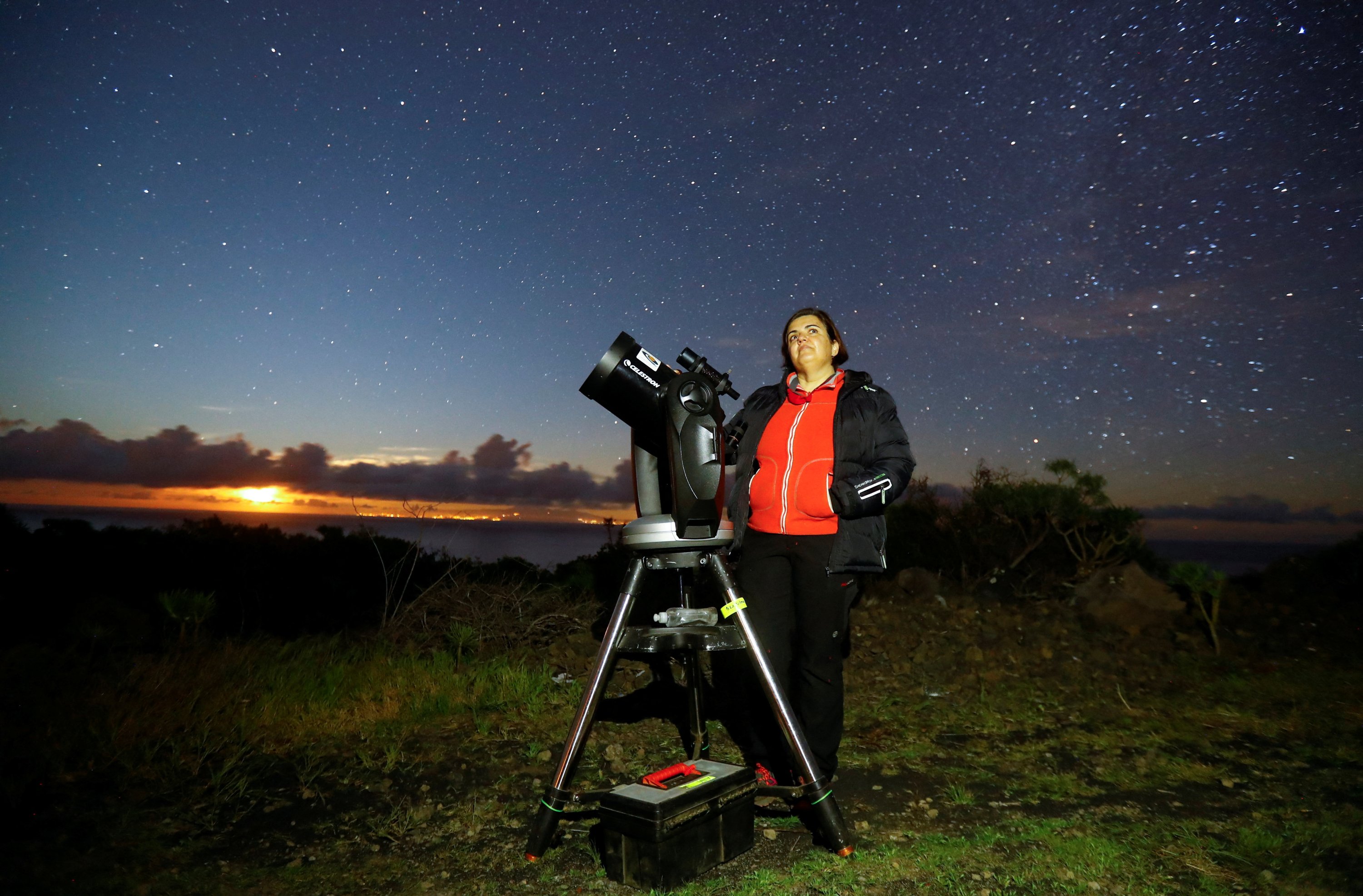 Astrophysicist Ana Garcia is photographed with her telescope in Mazo, on the Canary Island of La Palma. Spain, Jan. 23, 2022. (Reuters Photo)