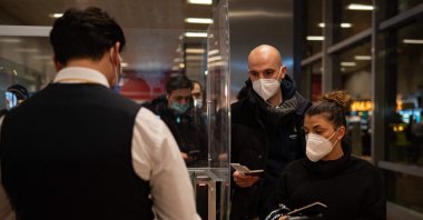 A man checks tickets before a Pegasus Airlines flight departs from Sabiha Gökçen International Airport to land at the Yerevan International Zvartnots Airport, Istanbul, Turkey, Feb. 2, 2022. (AFP Photo)