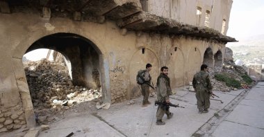 PKK terrorists walk in the damaged streets of Sinjar, Iraq, Jan. 29, 2015. (AP File Photo)