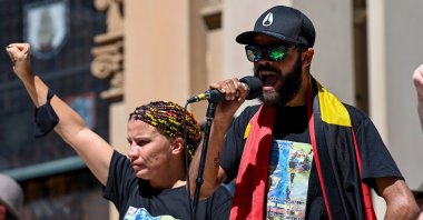 Indigenous activist and proud Dunghutti, Gumbaynggirr, Bundjalung woman Lizzy Jarret (L) and Paul Silva (R), a nephew of David Dungay Jr., speak during a rally on Australia Day. Australia's Indigenous peoples see the day marking the beginning of the colonization of their people and land and refer to it as "Invasion Day," Sydney, Australia, Jan. 26, 2022.  (EPA Photo)