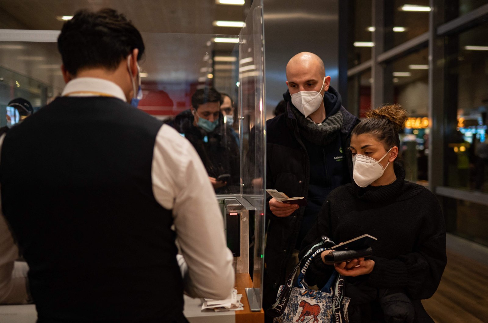 A man checks tickets before a Pegasus Airlines flight departs from Sabiha Gökçen International Airport to land at the Yerevan International Zvartnots Airport, Istanbul, Turkey, Feb. 2, 2022. (AFP Photo)