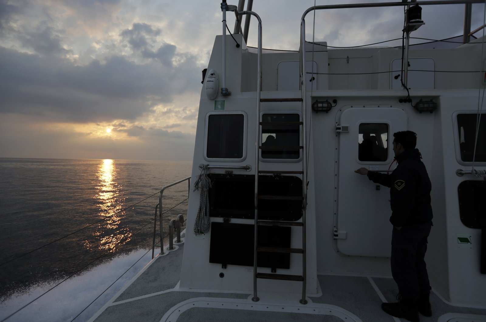 The sun rises as a Greek coast guard vessel patrols on the Aegean Sea near the northeastern Greek island of Lesbos, March 17, 2017. (AP File Photo)