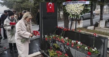 Şengül Hablemitoğlu leaves flowers on her husband Necip Hablemitoğlu&#039;s grave in the capital Ankara, Turkey, Dec. 18, 2019. (AA Photo)