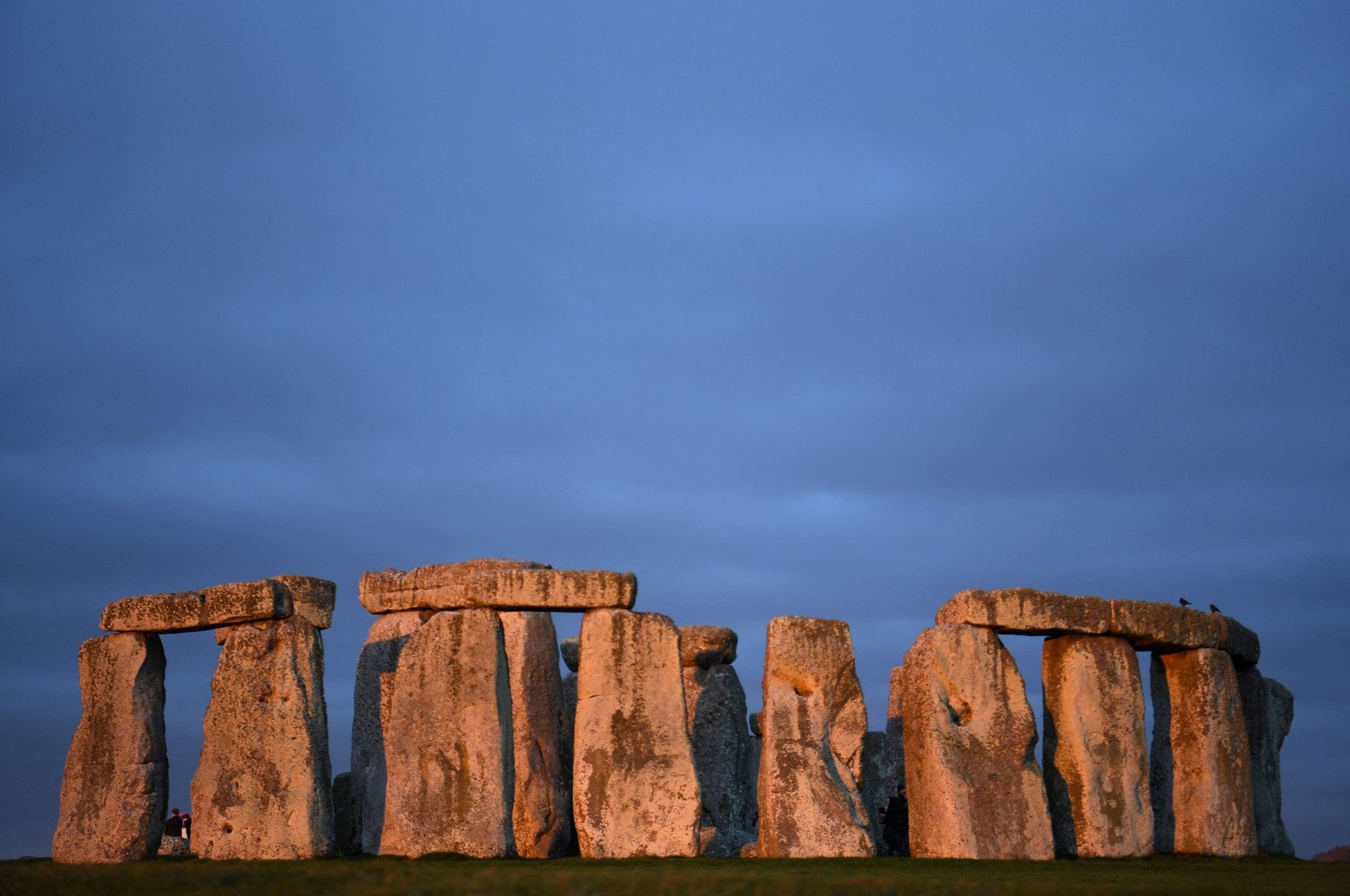 The sun rises at the prehistoric monument Stonehenge near Amesbury, southern England, Jan. 19, 2022. (AFP Photo)