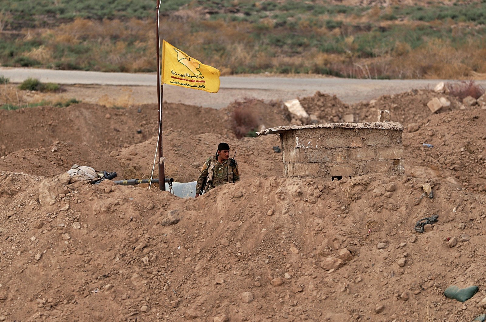 A YPG terrorist seen at the Syrian side of the border with Iraq near the Rabia border crossing, Iraq, Oct. 16, 2019. (AP File Photo)