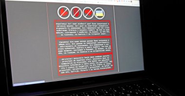 A laptop screen displays a warning message in Ukrainian, Russian and Polish, that appeared on the official website of the Ukrainian Foreign Ministry after a massive cyberattack, Jan. 14, 2022. (Reuters Photo)
