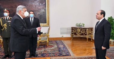 In this photo provided by Egypt's presidential media office, Egyptian President Abdel-Fattah el-Sissi, (R), swears in Judge Boulos Fahmy, as the first-ever Coptic Christian to head the country’s highest court, in Cairo, Egypt, Feb. 9, 2022. (AP Photo)