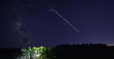 This time-exposure image shows a trail of a group of SpaceX&#039;s Starlink satellites passing over Uruguay, some 185 kilometers north of the capital Montevideo, Feb. 6, 2021. (AFP Photo)