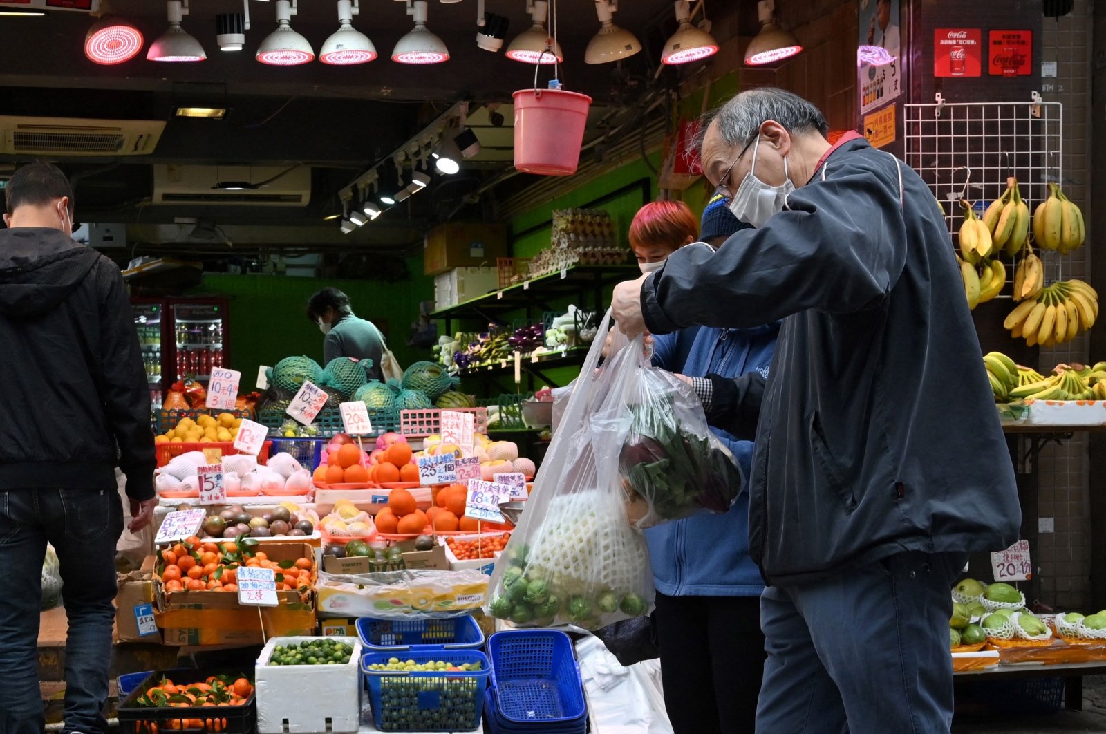 Shoppers buy vegetables a day after many shops ran out of some products in Hong Hong, Feb. 9, 2022. (AFP Photo)