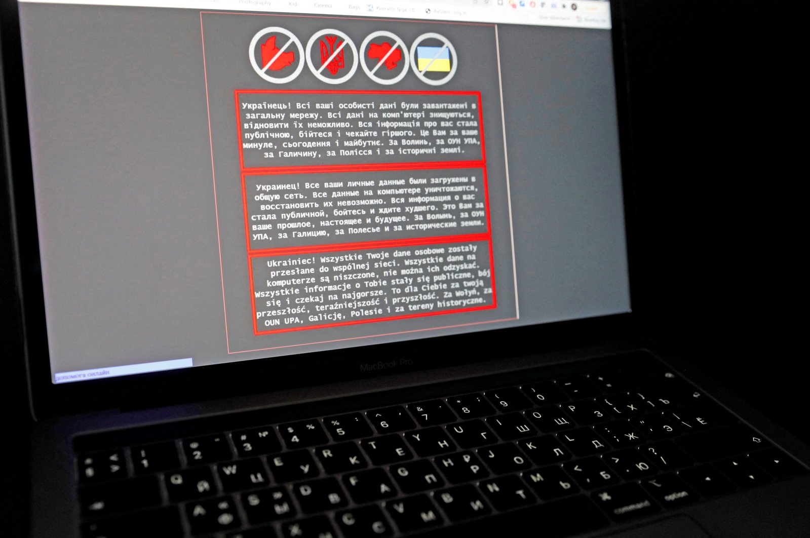 A laptop screen displays a warning message in Ukrainian, Russian and Polish, that appeared on the official website of the Ukrainian Foreign Ministry after a massive cyberattack, Jan. 14, 2022. (Reuters Photo)
