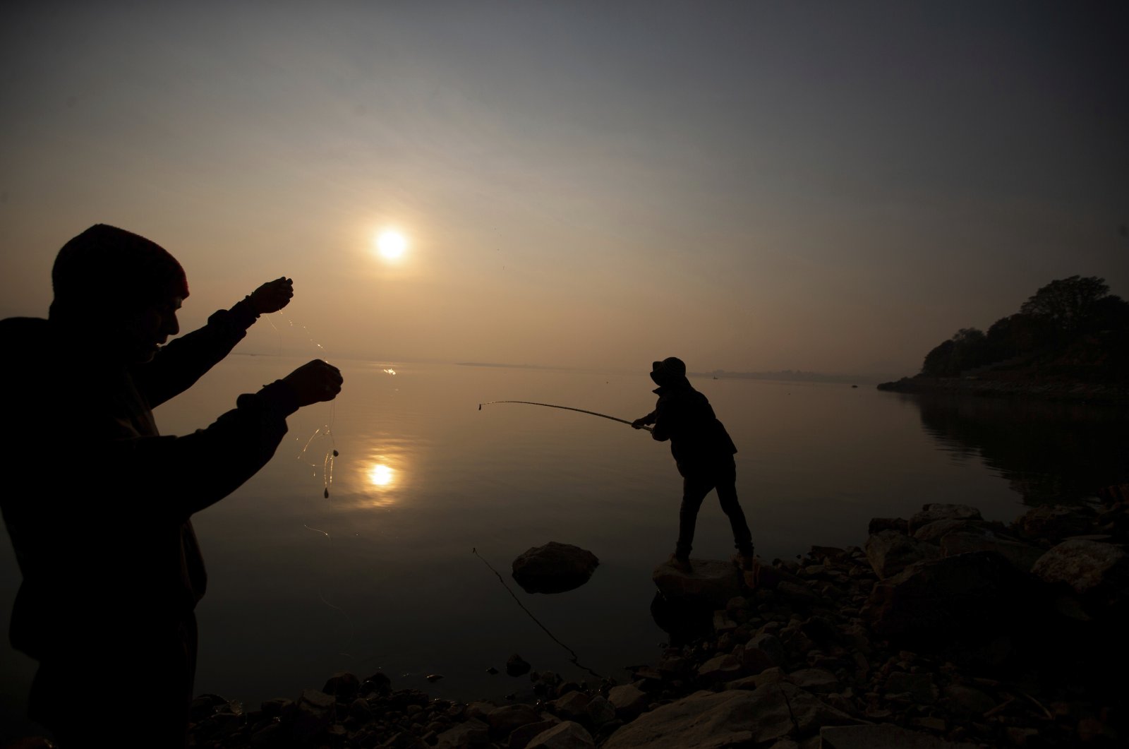 People fish off the banks of the Villa Victoria Dam, the main water supply for Mexico City residents, on the outskirts of Toluca, Mexico, April 22, 2021. (AP Photo)