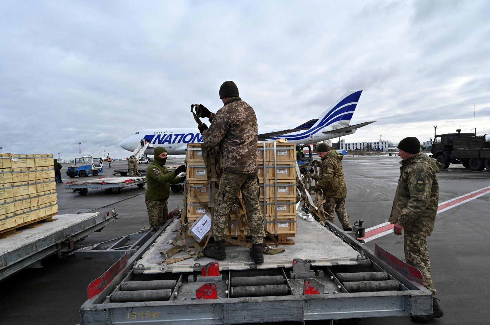 Servicemen of Ukrainian Military Forces unload a Boeing 747-412 of National Airlines carrying U.S. military aid at Kyiv&#039;s Boryspil airport on Feb. 9, 2022. (AFP File Photo)