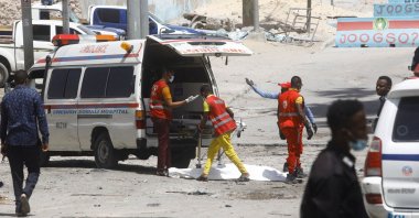 Paramedics prepare to transport the body of an unidentified man killed in an explosion at a checkpoint near the presidential palace in Mogadishu, Somalia, Feb. 10, 2022. (Reuters Photo)