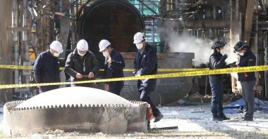 Police officers examine a Yeochun NCC factory following an explosion earlier in the day, about 320 kilometers south of Seoul, South Korea, Feb. 11, 2022. (EPA Photo)