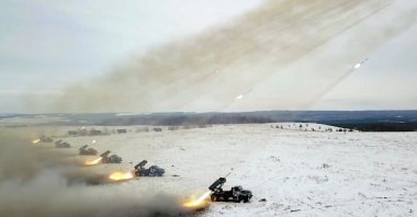 In this image taken from video and released by Russian Defense Ministry Press Service, Russian rocket launchers fire during military drills near Orenburg in the Urals, Russia, Thursday, Dec. 16, 2021. (Russian Defense Ministry Press Service via AP)