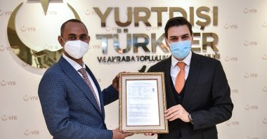 Somali Defense Minister Abdulkadir Mohamed Nur (L), a former Türkiye Scholarships beneficiary, poses with Abdullah Eren, head of the Presidency for Turks Abroad and Related Communities, the organization that provides the scholarships, in the capital Ankara, Turkey, Dec. 26, 2020. (AA PHOTO)