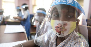 A student wearing facemasks and face-shield attends a class after the reopening of schools closed as a preventive measure to curb the spread of COVID-19, at a government girls primary school in Hyderabad, India on Feb. 11, 2022. (AFP Photo)