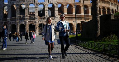 People walk near the Colosseum without wearing face masks on the day Italy's government lifted the obligation to wear masks outdoor following a decline in COVID-19 cases, in Rome, Italy, Feb. 11, 2022. (Reuters Photo)