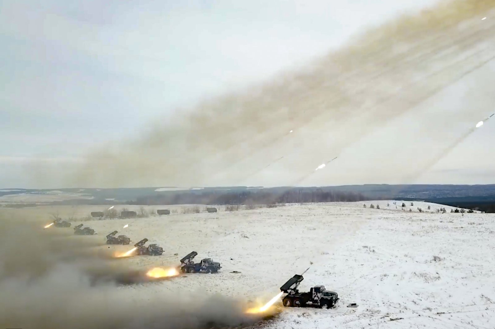 In this image taken from video and released by Russian Defense Ministry Press Service, Russian rocket launchers fire during military drills near Orenburg in the Urals, Russia, Thursday, Dec. 16, 2021. (Russian Defense Ministry Press Service via AP)
