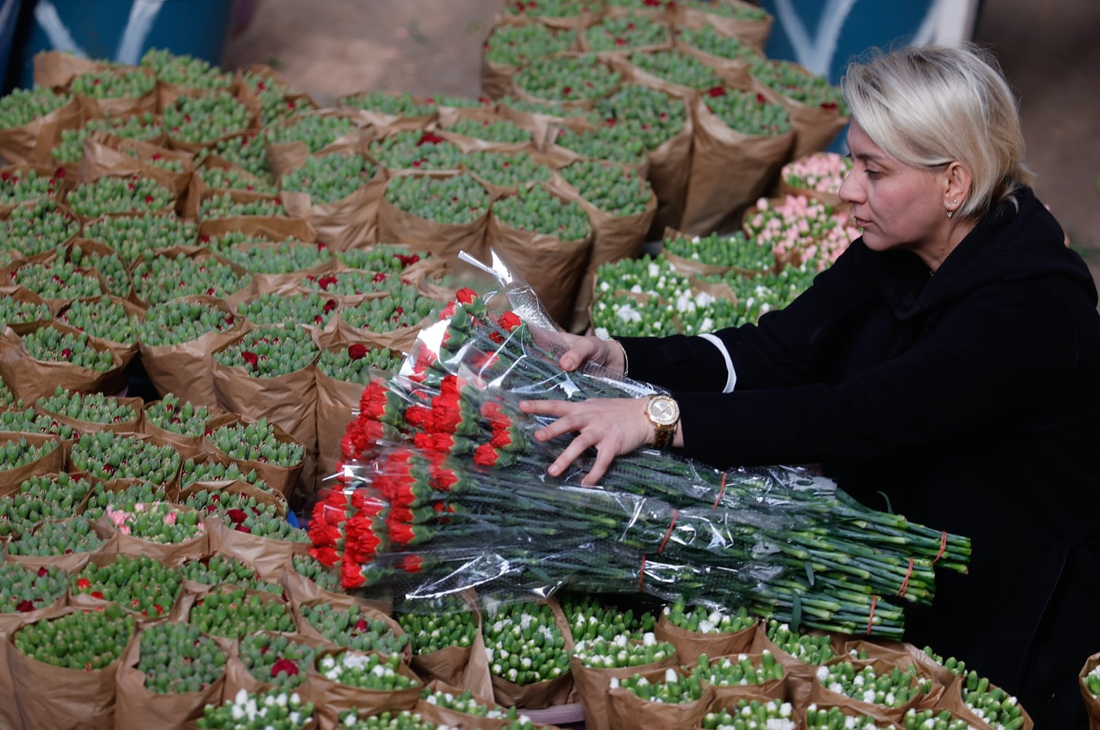 An employee arranges cut flowers in a greenhouse in Antalya, southern Turkey, Feb. 11, 2022. (AA Photo)