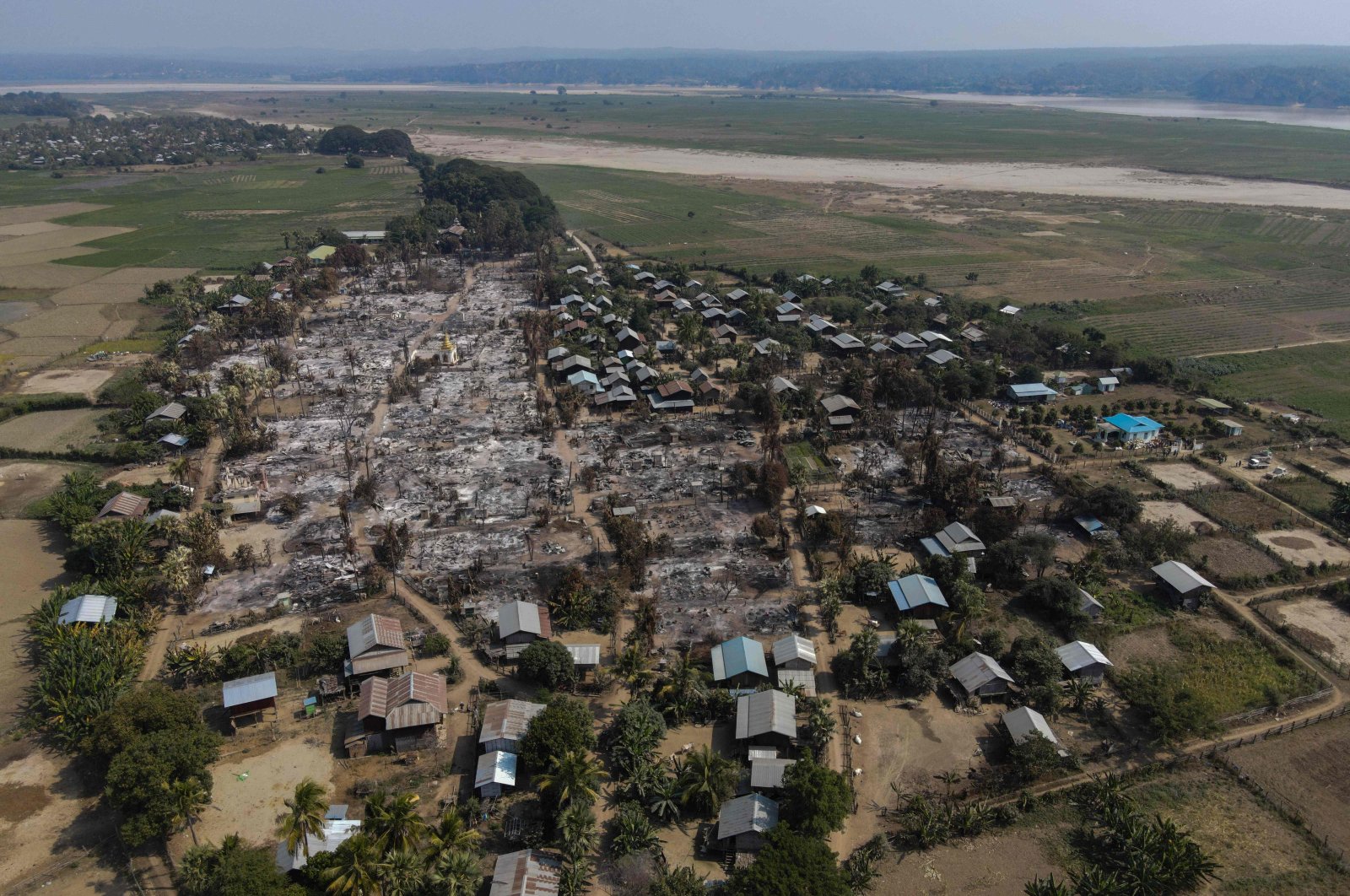 This handout photo by Chin Twin Chit Thu taken on Feb. 3, 2022 and released on Feb. 5, 2022 shows an aerial photo of burnt buildings from fires in Mingin Township, in Sagaing Division, where more than 105 buildings were destroyed by junta military troops, according to local media. (AFP File Photo)