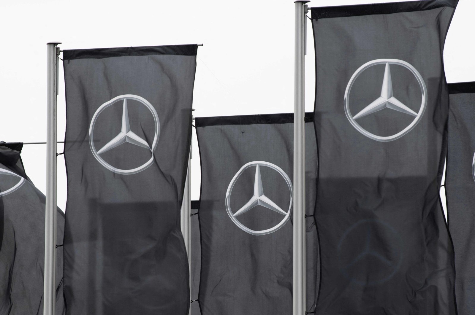 Flags with the Mercedes-Benz logo are seen in front of the Mercedes-Benz Museum in Stuttgart, southern Germany, Jan. 31, 2022. (AFP Photo)