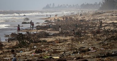 People search debris on the beach, in the aftermath of Cyclone Batsirai, in the town of Mananjary, Madagascar, Feb. 8, 2022. (Reuters Photo)