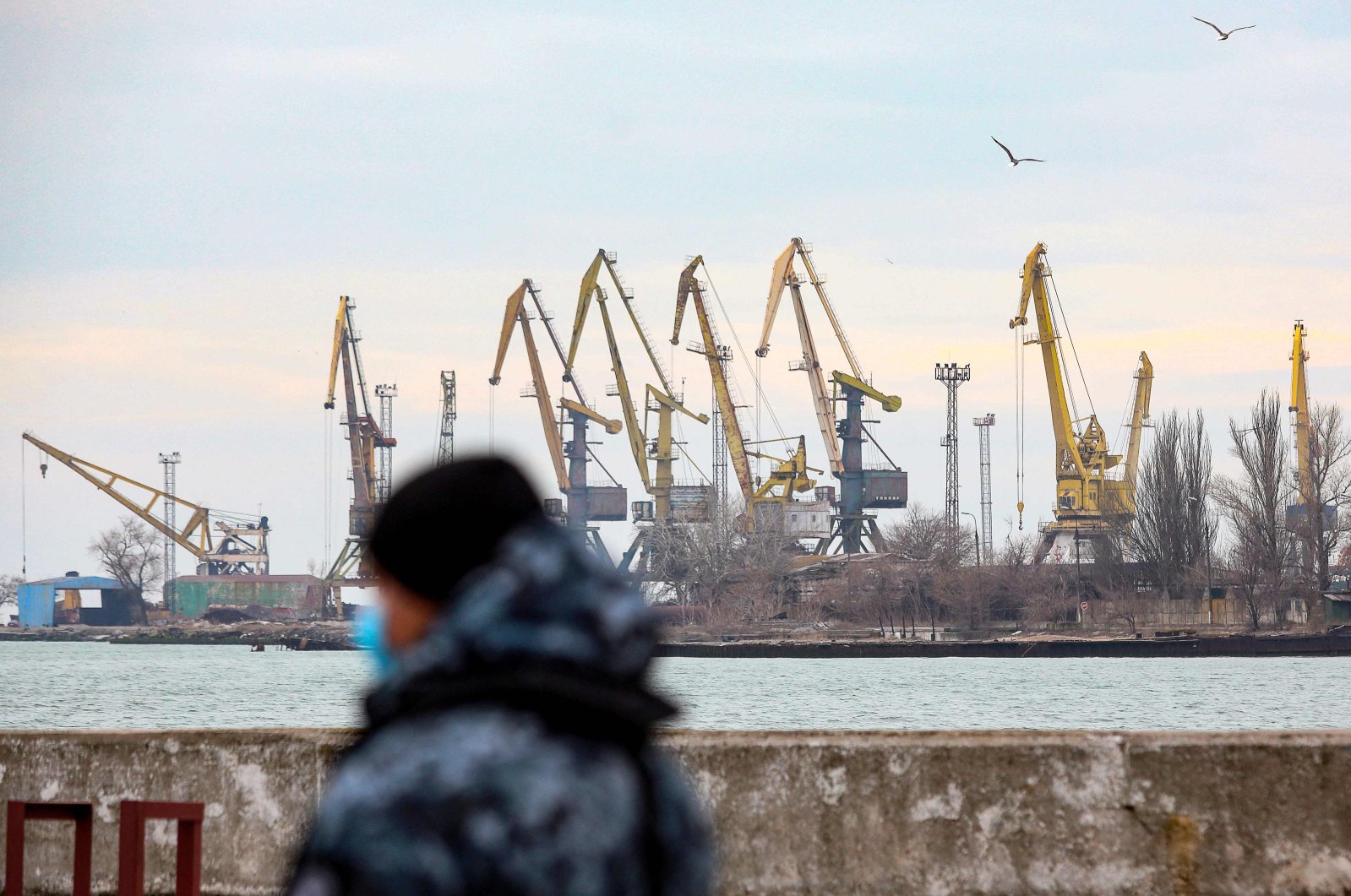 A security officer walks in the border base in front of the Black Sea port of Mariupol, Ukraine, Feb. 11, 2022. (AFP Photo)