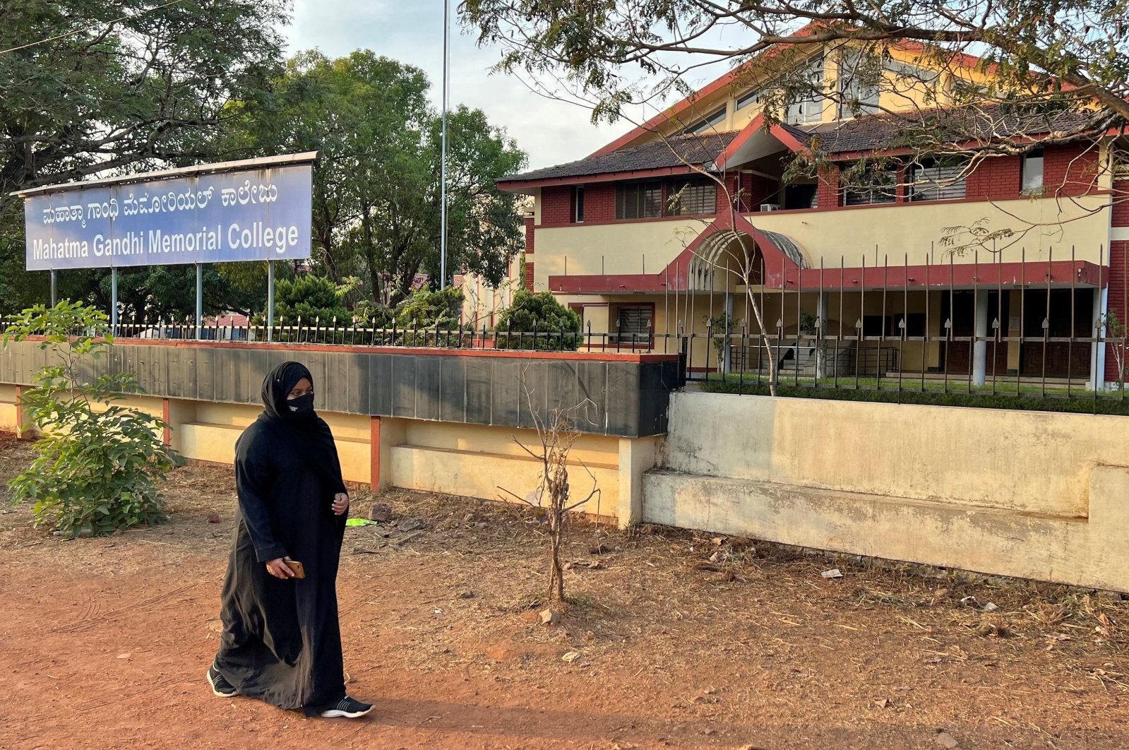 Ayesha Imthiaz, 21, a Muslim college student, wearing a hijab, walks past her college in Udupi, Karnataka state, India, Feb. 11, 2022. (Reuters Photo)