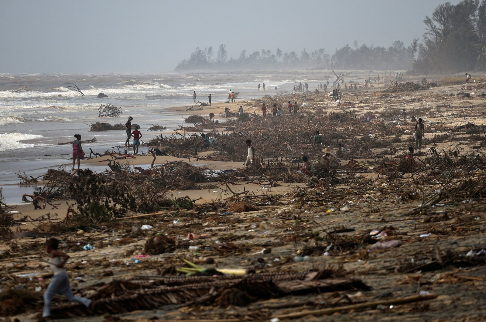 People search debris on the beach, in the aftermath of Cyclone Batsirai, in the town of Mananjary, Madagascar, Feb. 8, 2022. (Reuters Photo)