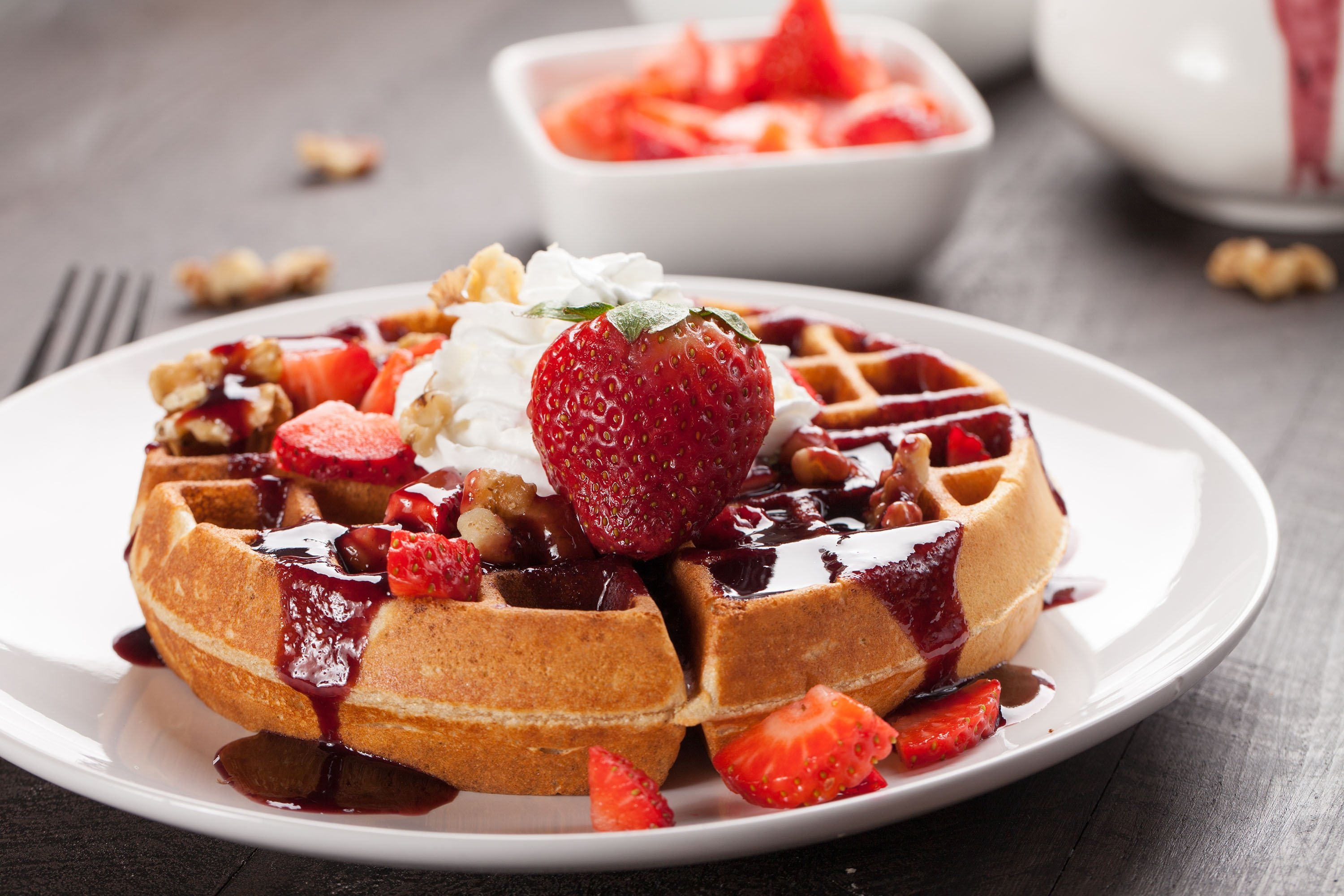 Waffles topped with boysenberry syrup and whipped cream. (Shutterstock Photo)