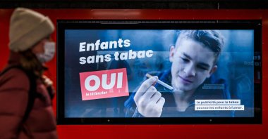An electoral placard reads in French: "Children without tobacco, YES," in Lausanne, Switzerland, Feb. 8, 2022. (AFP Photo)