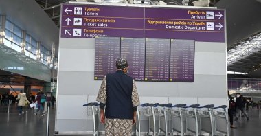 A man looks at the departures board ahead of flights at the Boryspil airport some 30 kilometers outside Kyiv, Ukraine, Feb. 13, 2022. (AFP Photo)