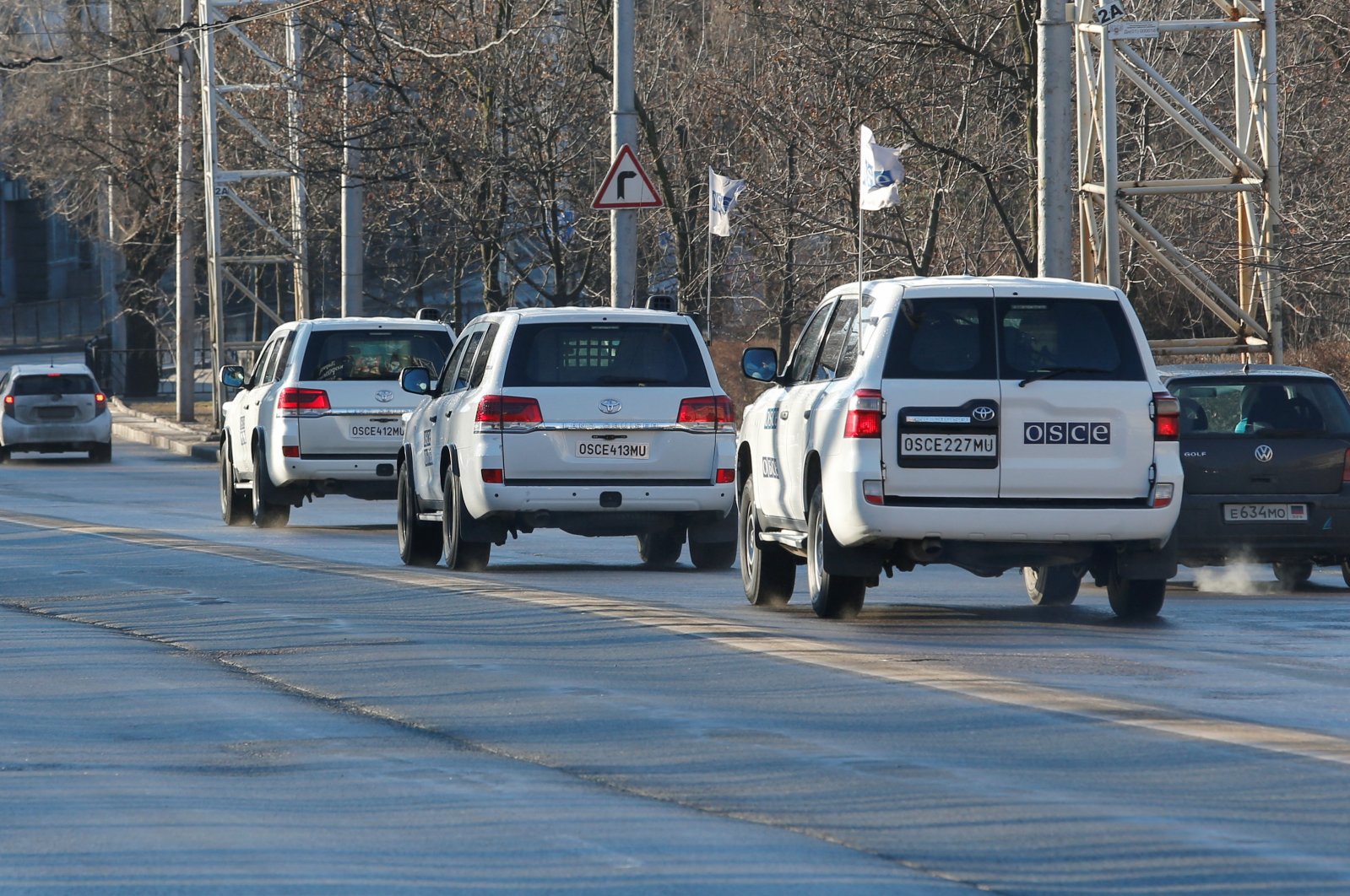 Cars of the Organization for Security and Co-operation in Europe (OSCE) drive along a road after leaving the territory of the Park Inn hotel housing the monitoring mission in the separatist-controlled city of Donetsk, Ukraine, Feb. 13, 2022. (Reuters Photo)