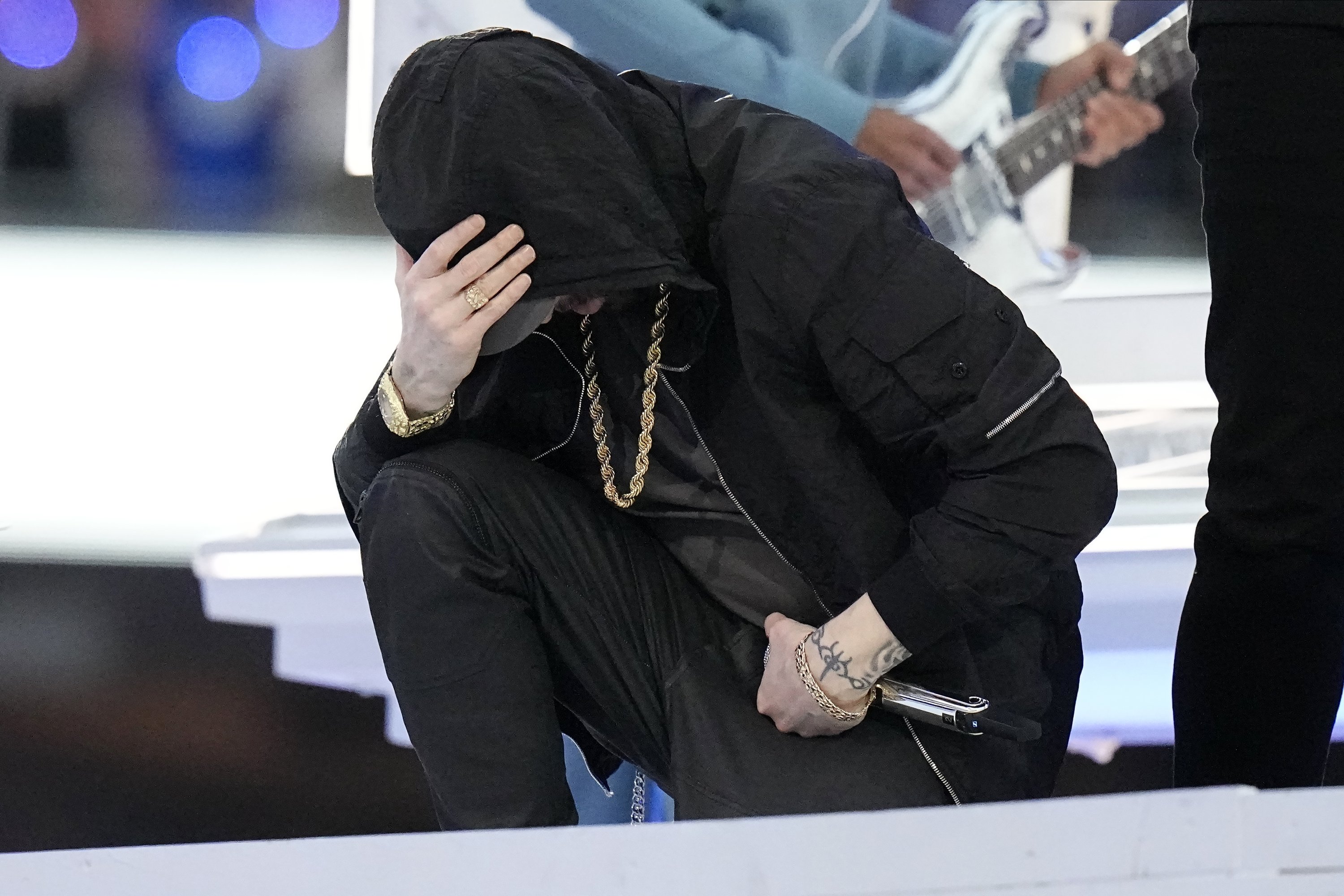 Eminem kneels down during the halftime performance at the NFL Super Bowl 56 football game between the Los Angeles Rams and the Cincinnati Bengals, Feb. 13, 2022, Inglewood, California, U.S. (AP Photo)