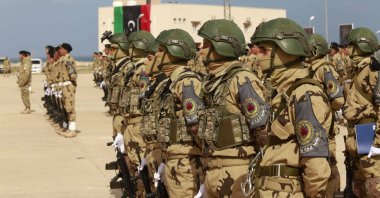 Libyan army cadets stand at attention for an audience including the prime minister, the commander of the Turkish training mission and other dignitaries at their graduation ceremony in Tripoli, Libya, Feb. 8, 2022. (AP Photo)