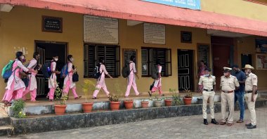 Schoolgirls arrive to attend classes as police officers stand inside the premises of a government girls school after the recent hijab ban, in Udupi town in the southern state of Karnataka, India, Feb. 14, 2022. (Reuters Photo)