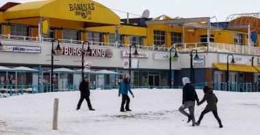 People walk on the frozen beach in Wasaga Beach, Ontario, Canada, Feb. 9, 2022. (Reuters Photo)