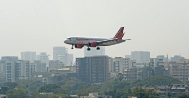 An Air India aircraft prepares to land at the Chhatrapati Shivaji Maharaj International Airport in Mumbai, India, Jan. 27, 2022. (Photo by Indranil MUKHERJEE / AFP)