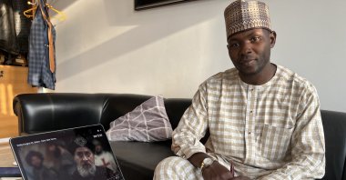 Nigerian Zunnurayn Abdul-Wahab poses with a laptop playing "Diriliş Ertuğrul," Nigeria, Feb. 14, 2022. (AA Photo)