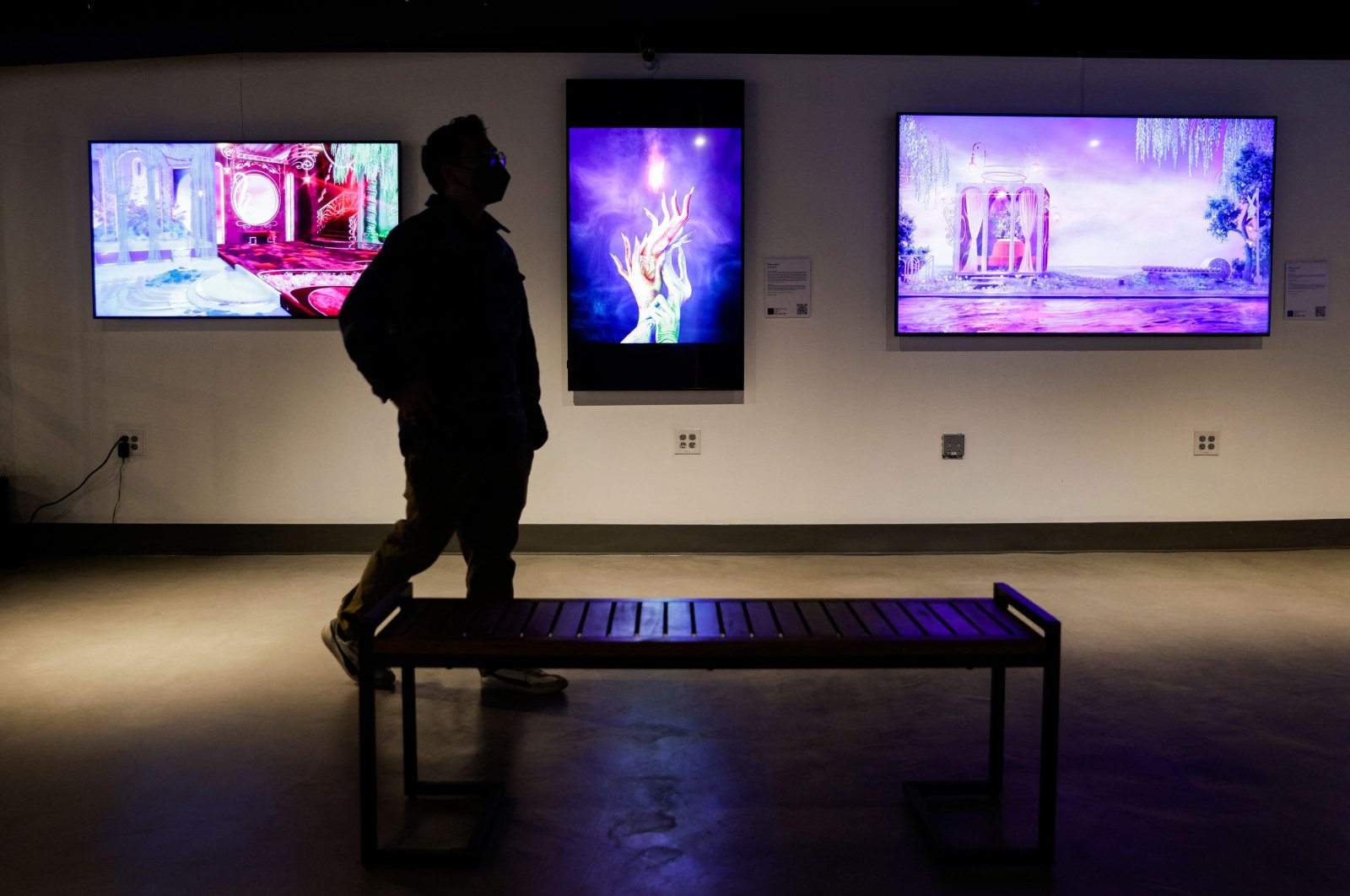 A visitor walks among artwork on display during the opening weekend of the Seattle NFT Museum in Seattle, Washington, U.S., Jan. 29, 2022. (AFP Photo)