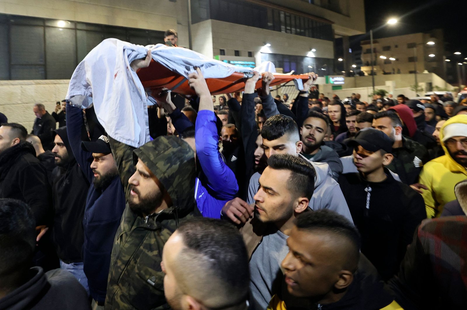 Palestinians carry the body of Mohammed Abu Salah, 17, after he was killed by Israeli forces during clashes near Jenin in the occupied West Bank, Palestine, Feb. 14, 2022. (AFP Photo)