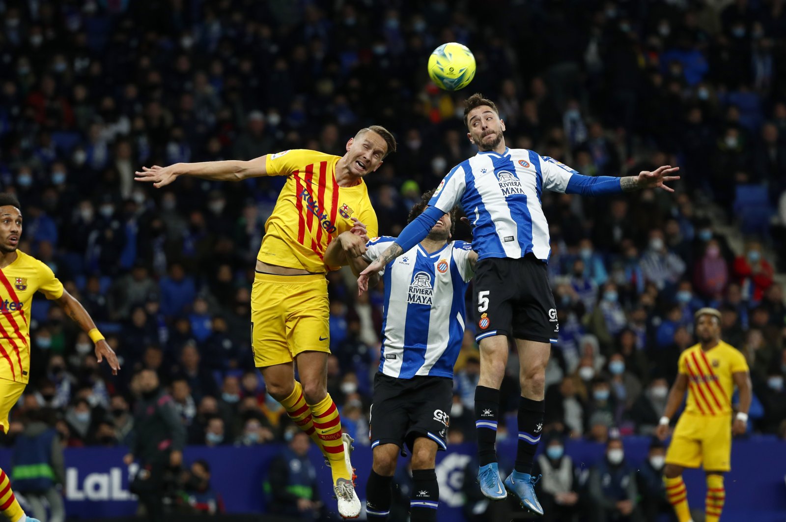 Barcelona&#039;s Luuk de Jong (2nd L) jumps for the ball with Espanyol&#039;s Fernando Calero (2nd R) during a La Liga match, Barcelona, Spain, Feb. 13, 2022. (AP Photo)