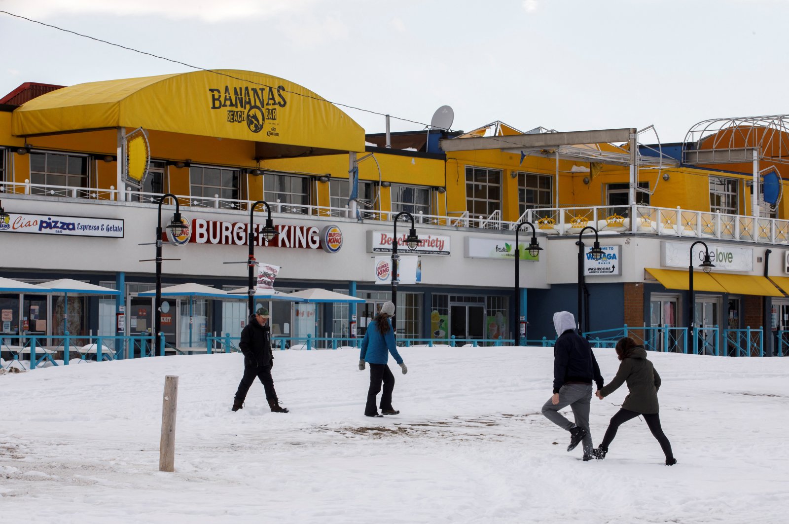 People walk on the frozen beach in Wasaga Beach, Ontario, Canada, Feb. 9, 2022. (Reuters Photo)