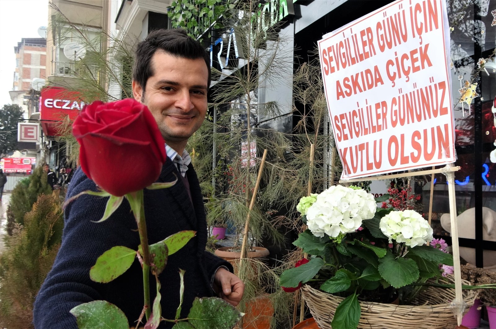 Tansel Bahat shows the flowers he gives away, in Elazığ, eastern Turkey, Feb. 14, 2022. (IHA Photo)