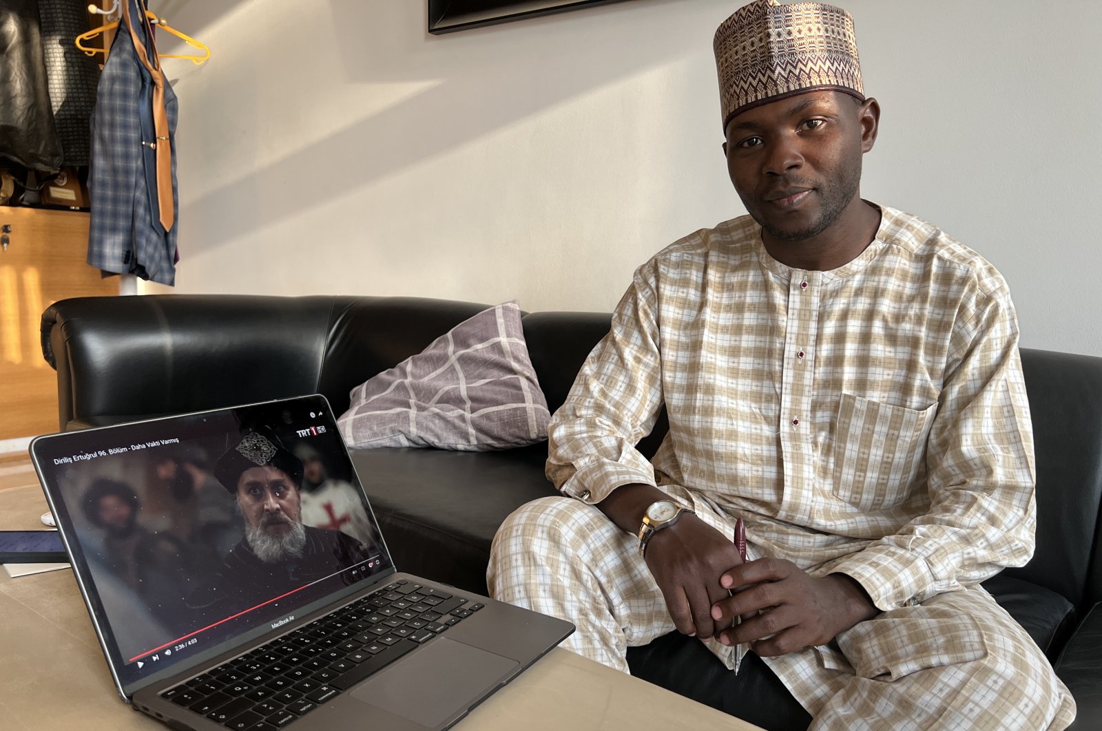 Nigerian Zunnurayn Abdul-Wahab poses with a laptop playing &quot;Diriliş Ertuğrul,&quot; Nigeria, Feb. 14, 2022. (AA Photo)