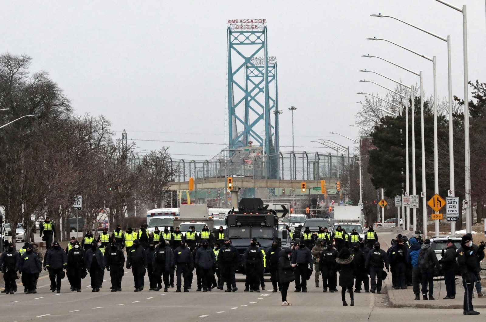 Police gather to disperse protestors against Covid-19 vaccine mandates who blocked the entrance to the Ambassador Bridge in Windsor, Ontario, Canada, Feb. 13, 2022. (AFP)