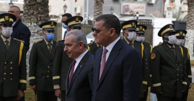 Libyan incumbent Prime Minister Abdul Hamid Dbeibah (C), greets Palestinian Prime Minister Mohammad Shtayyeh at the prime ministry headquarters, Tripoli, Libya, Monday, Feb. 14, 2022. (AP Photo)